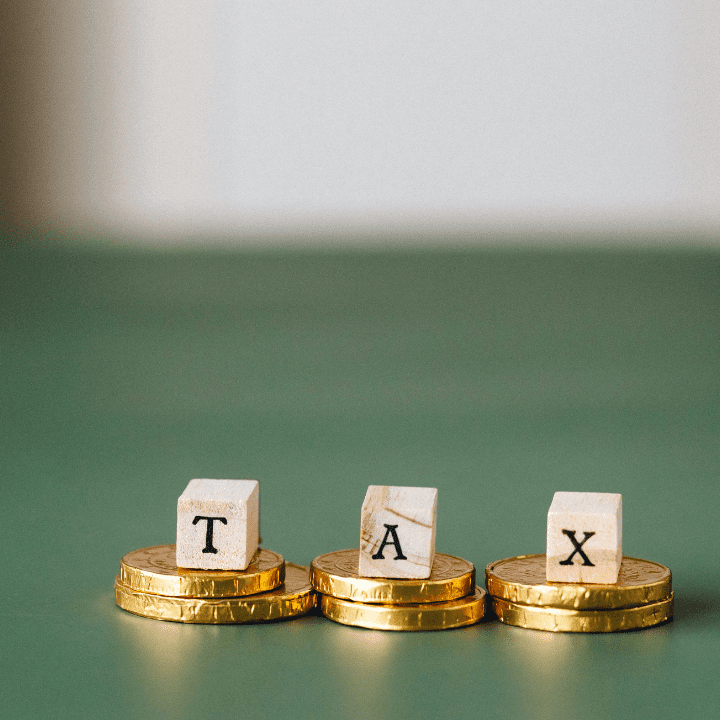 coins stacked with the word tax